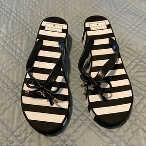 Kate Spade black and white striped platform flip flop sandals with gold accents
